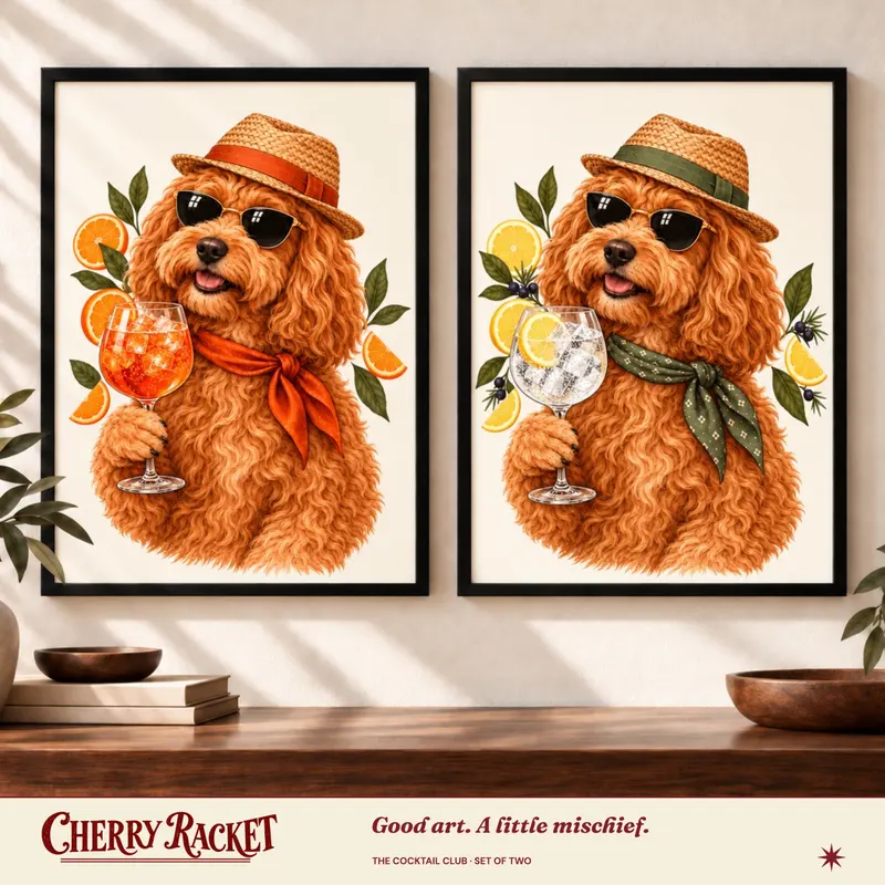 Styled room mockup showing Cockapoo Aperol Spritz and Cockapoo Gin & Tonic prints together. Frames not included.